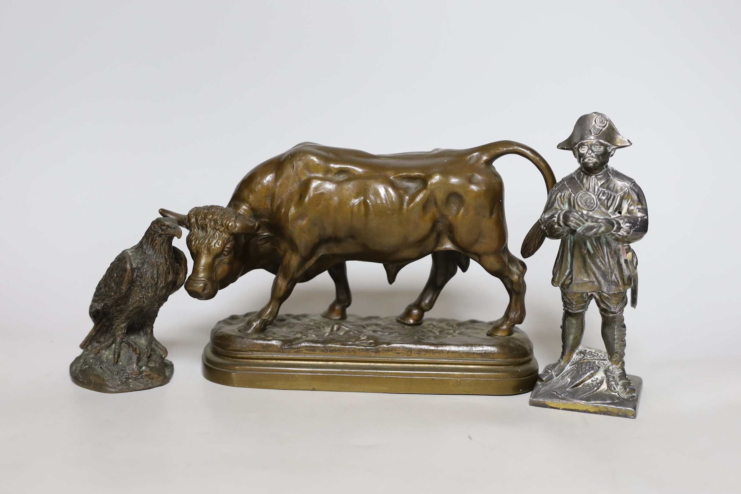 A bronze figure of a cow, together with two other figures, tallest 18cm